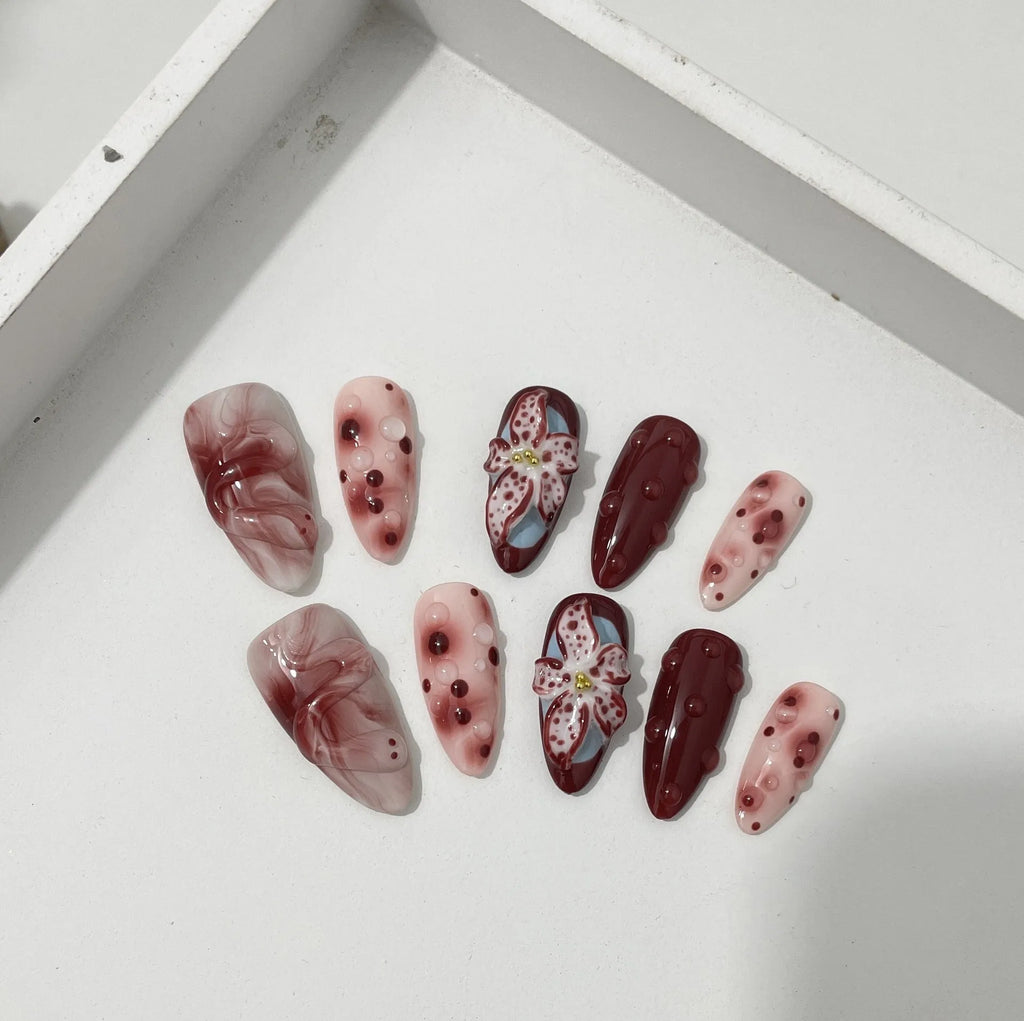 False nails with 3D carved floral and decorative patterns in almond shape, showing size options