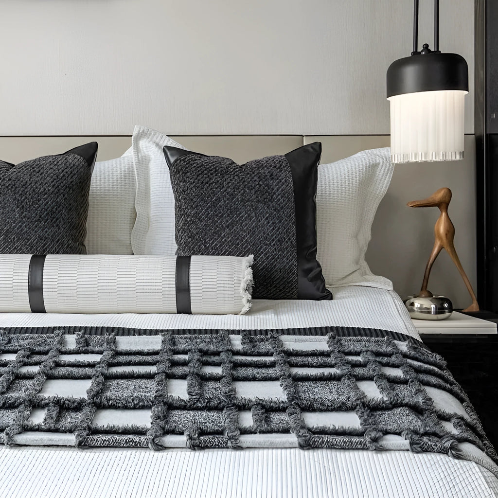 Modern minimalist grey and white plaid bed runner blanket set with matching pillow on a bed.