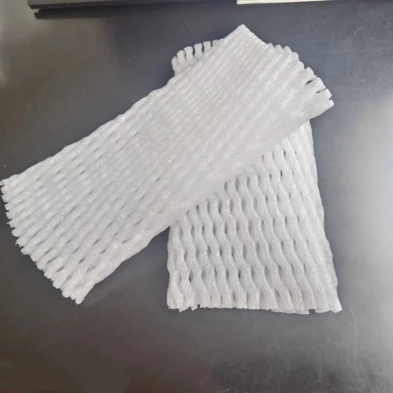 White foam protective case showing stretchable net construction for item cushioning
