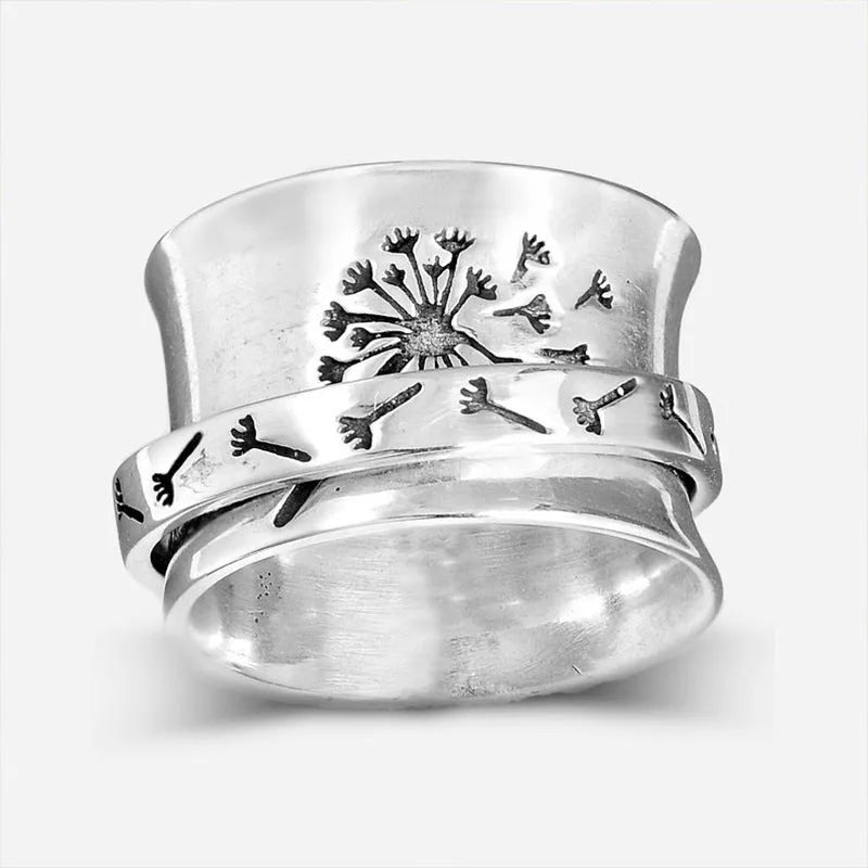 Silver rotating flower ring showing floral element and band details