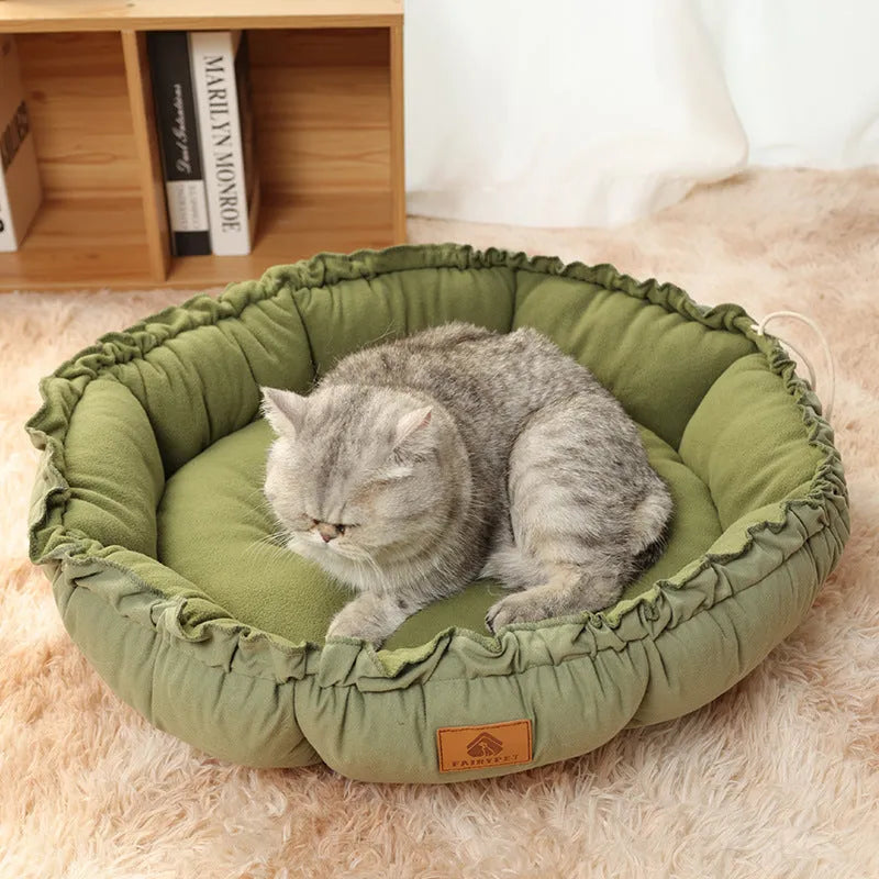 Grey reversible donut cat bed showing both raised rim side and flat sleeping side