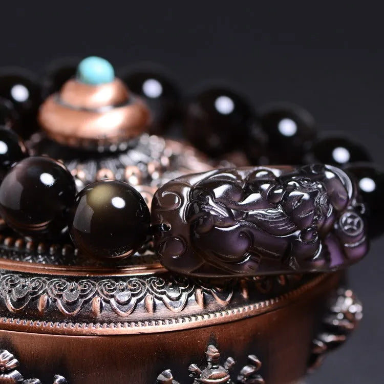 Polished natural crystal Pi Xiu bracelet with ethnic geometric design on a wrist