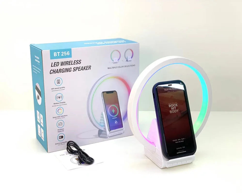 White smart Bluetooth speaker with built-in ambient light and 15W wireless charging pad on top.