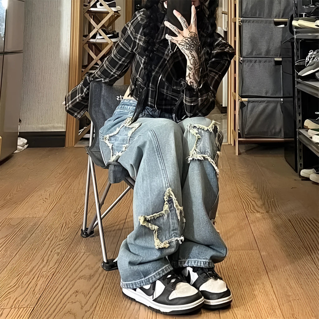 Blue high-waisted wide-leg denim trousers on a hanger, showing the straight-leg silhouette.
