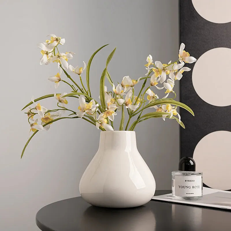 Round belly French design ceramic vase in coloured glaze finish with artificial orchid flowers
