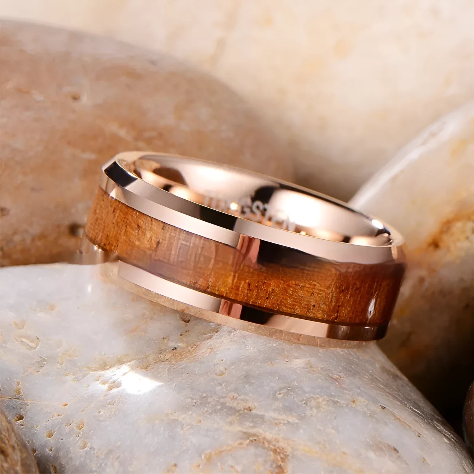 Men's 8mm wide tungsten ring with wood and leather inlay in rose gold or steel finish.
