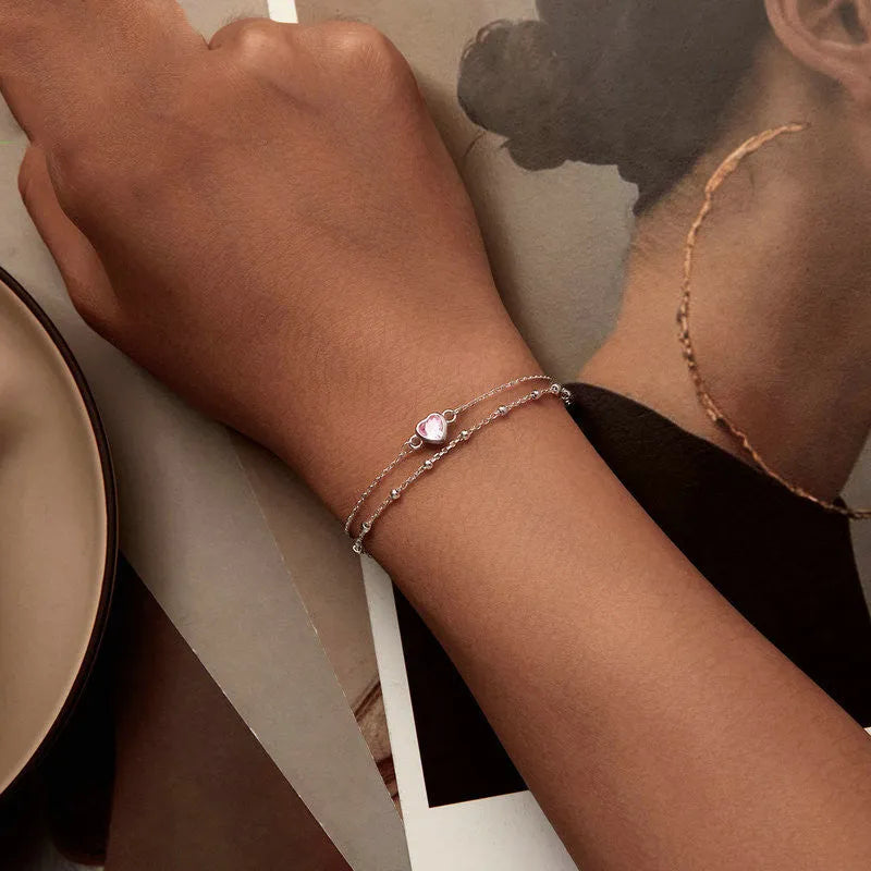 Sweet girlish sterling silver bracelet with a small heart-shaped pendant on an adjustable chain.