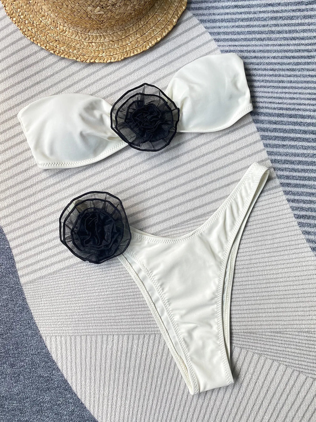 Black floral split bikini swimsuit set with tube top and briefs on a mannequin.