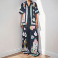 Black women's cartoon print polyester lounge set with cardigan sleeve top and matching trousers