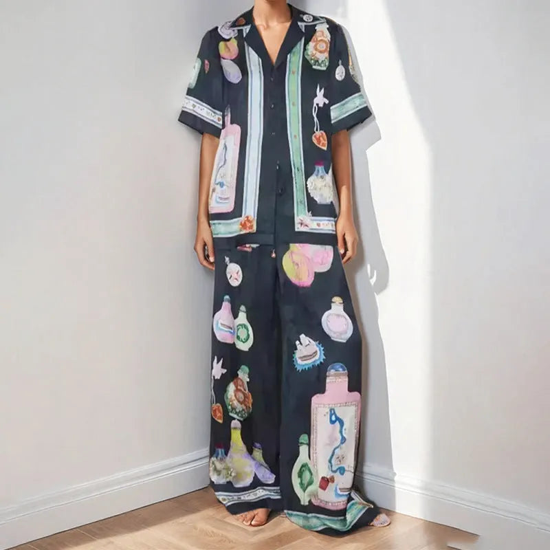 Black women's cartoon print polyester lounge set with cardigan sleeve top and matching trousers