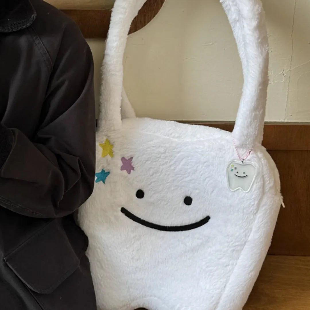 White plush large tooth design shoulder tote bag with a zipper, shown as a unisex crossbody bag.