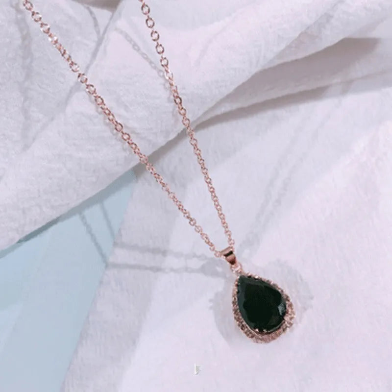 Women's rose gold drop shape necklace with rhinestone details on an alloy chain.