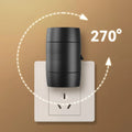 Small white plug-in night lamp with rotatable head showing adjustable brightness control, plugged into wall socket