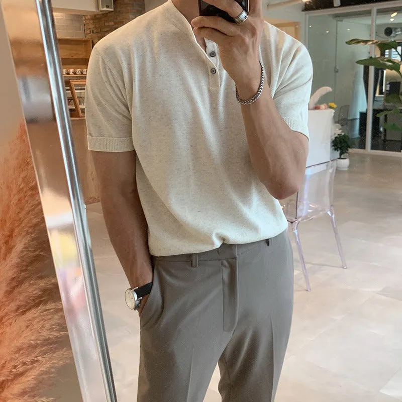 Man wearing a thin black slim-fit knitted short-sleeved shirt.