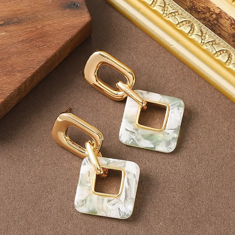 Copper hollow geometric square earrings with electroplated finish, chamfered corners, and two colour options