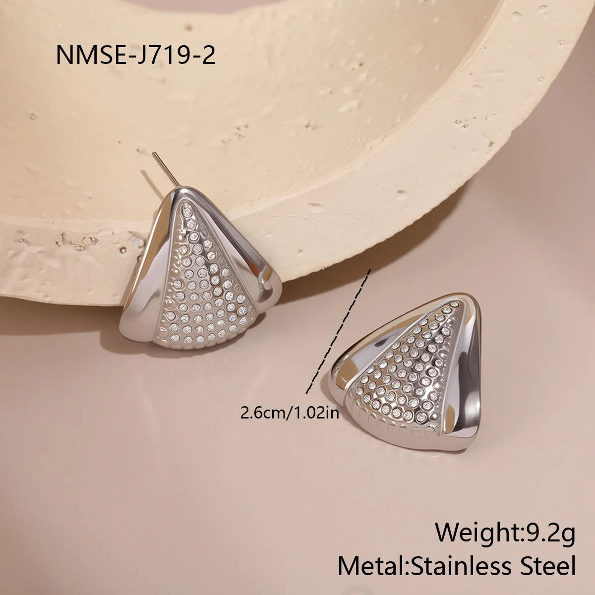 Gold triangle stainless steel geometric stud earrings with electroplated finish on white background