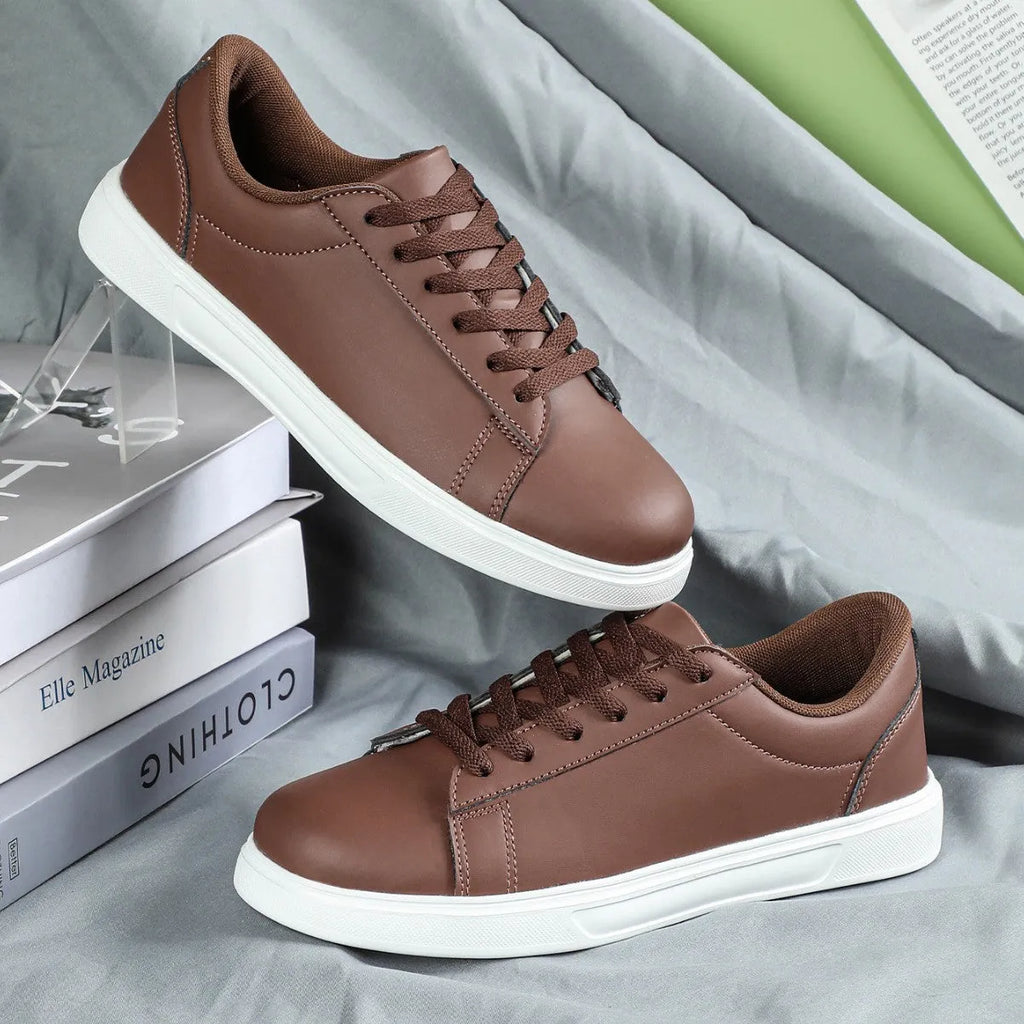 Beige brown platform casual sneaker with cross-belt detail and a low-top silhouette on a white background.