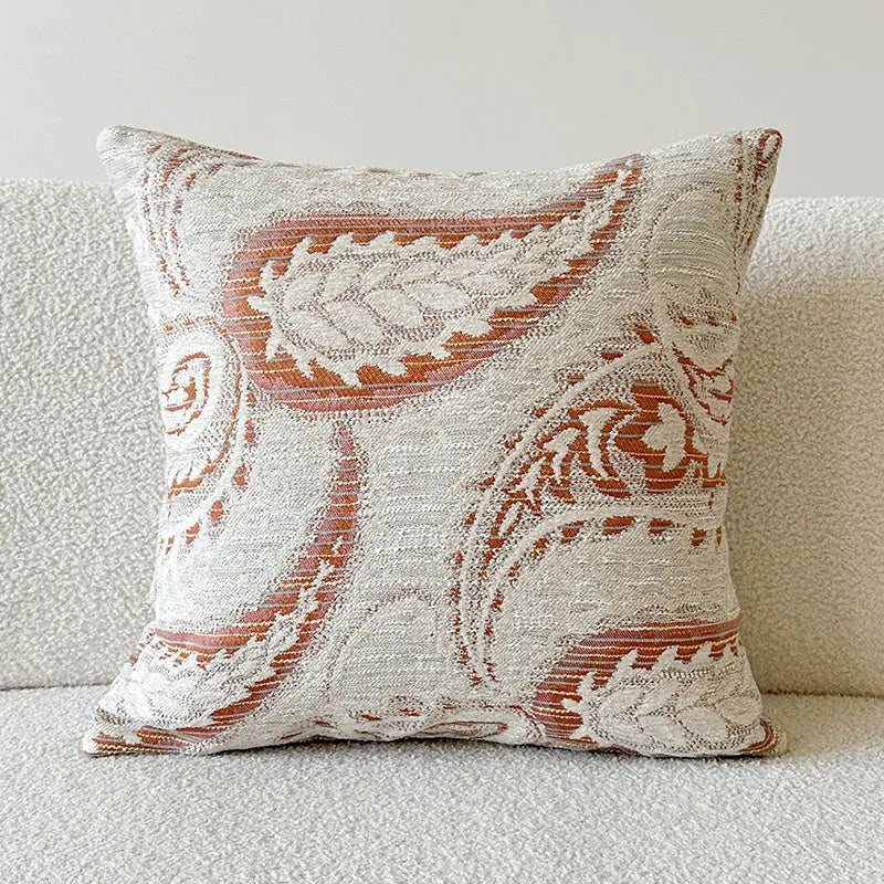 American-style amber jacquard pillow cover with paisley plant pattern, shown on a sofa.