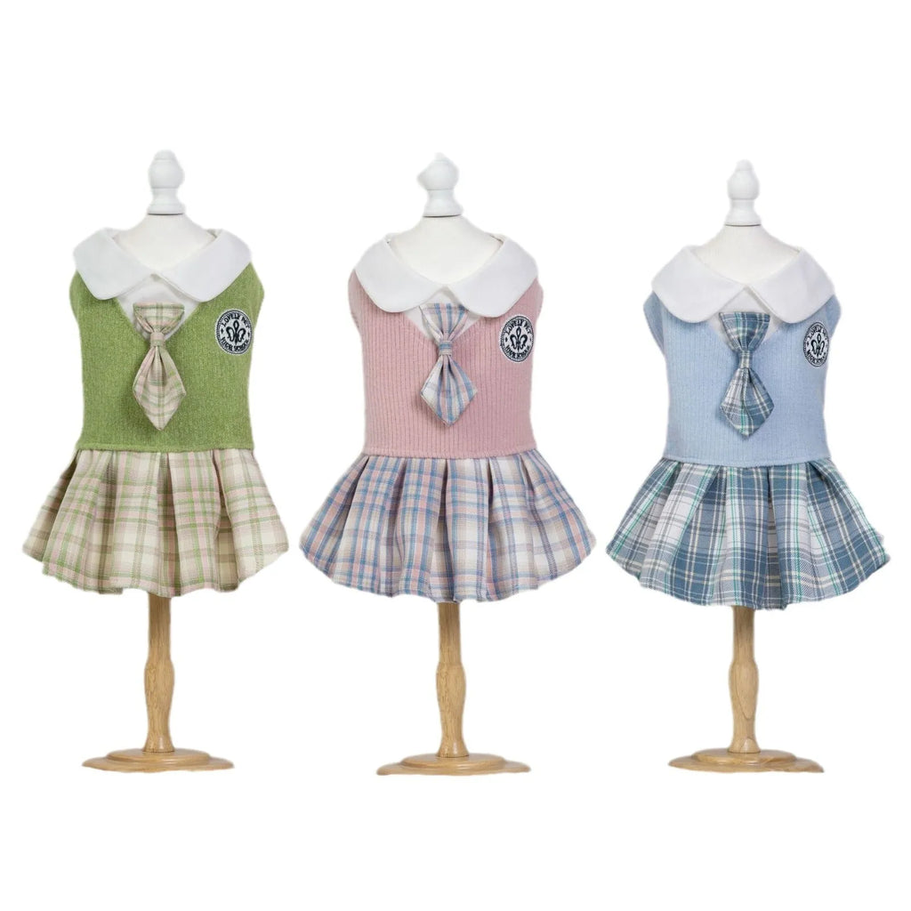A pink tartan skirt for small dogs and cats with an adjustable velcro waist closure.