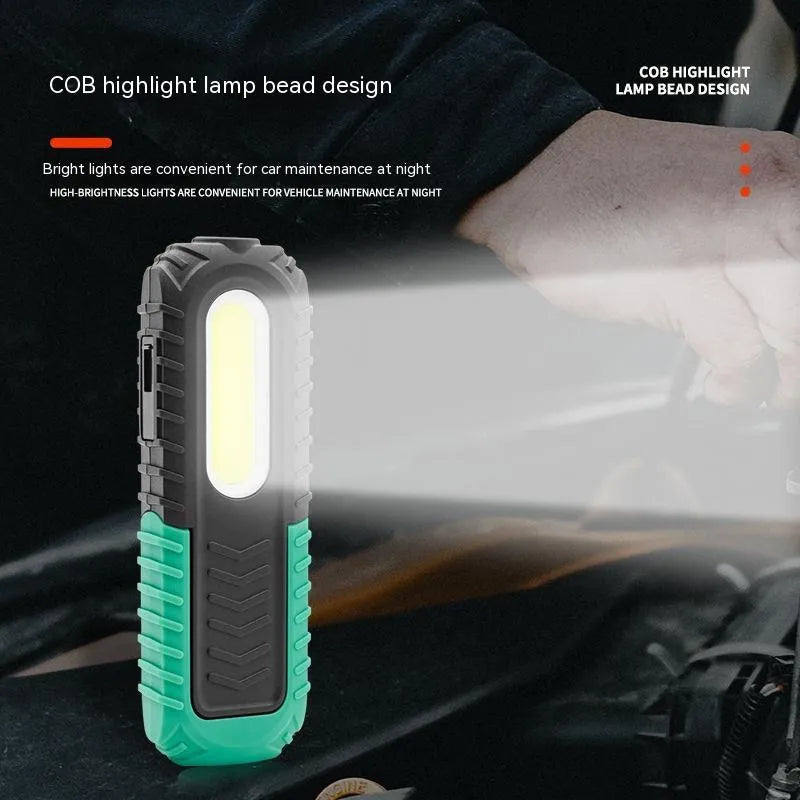 Black and green USB-charging auto repair work light with compact handheld design