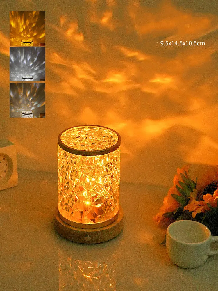 Small rotating water ripple night light with acrylic shade on a solid wood base.