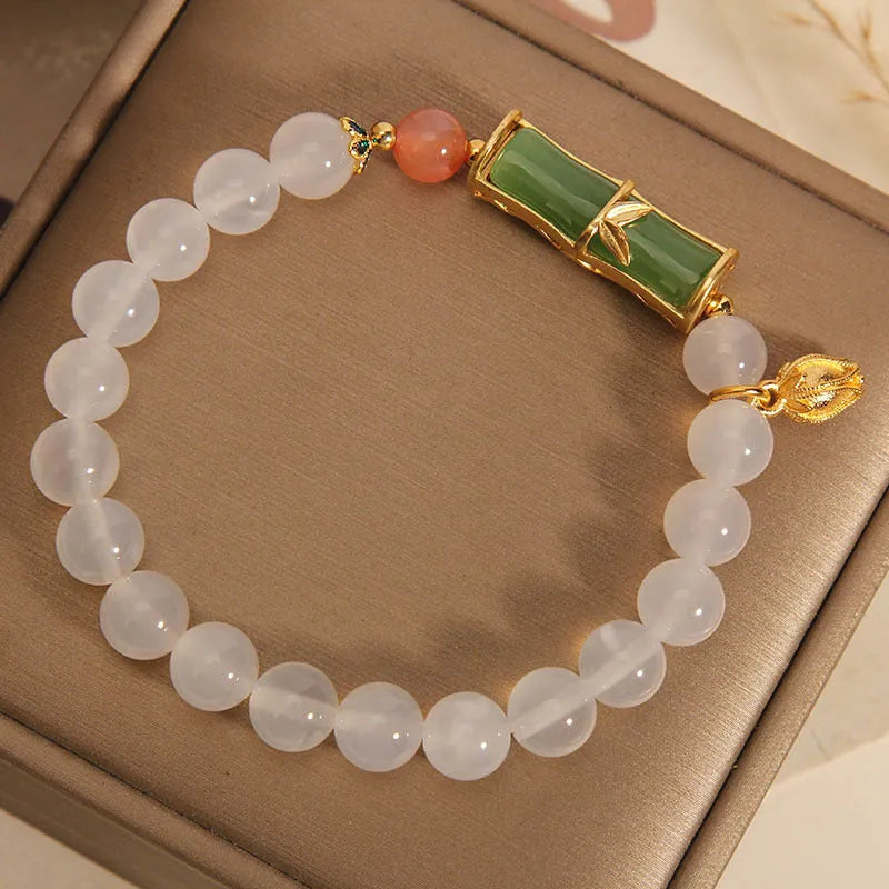 White agate and jade bamboo beaded bracelet on wrist, natural stone jewellery for women