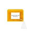 Facial care kit with turmeric cleansing mousse 490g, facial cleaning pads, and ginger granule soap on white background