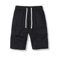 Men's multi-pocket loose cropped pants in black, side view showing multiple pockets and loose fit