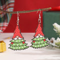 Women's wooden Christmas earrings with printed tree and snowman designs on geometric shapes.