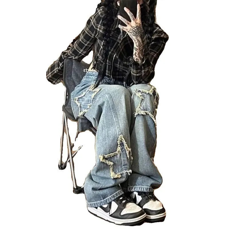 Blue high-waisted wide-leg denim trousers on a hanger, showing the straight-leg silhouette.