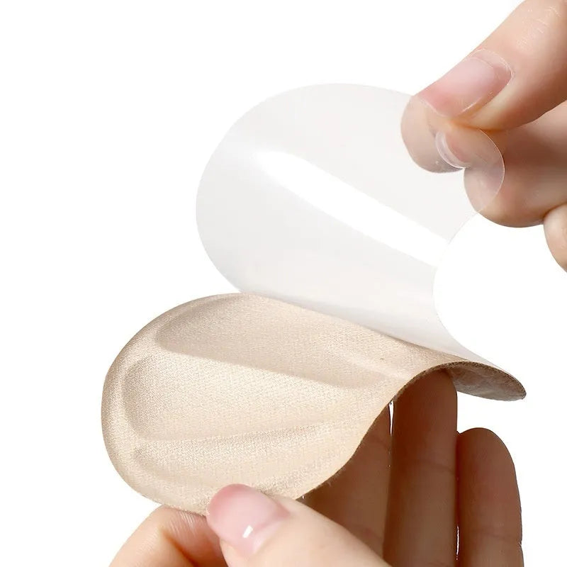 Three pairs of camel-coloured suede anti-slip heel cushion pads for shoes, shown with adhesive backing.