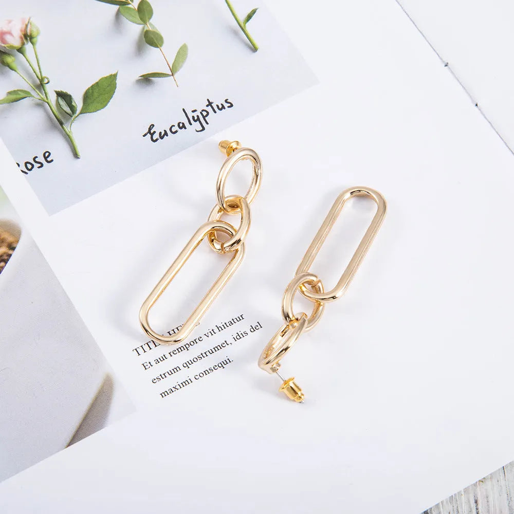 Sterling silver geometric hoop earrings with ring and line design elements