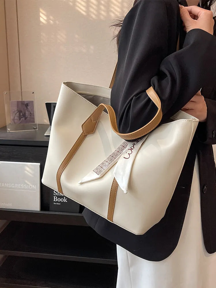 Women's large capacity soft tote bag with crossbody strap showing zipper compartment interior