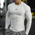 Man wearing black slim-fit long sleeve fitness tights for running or gym workout.