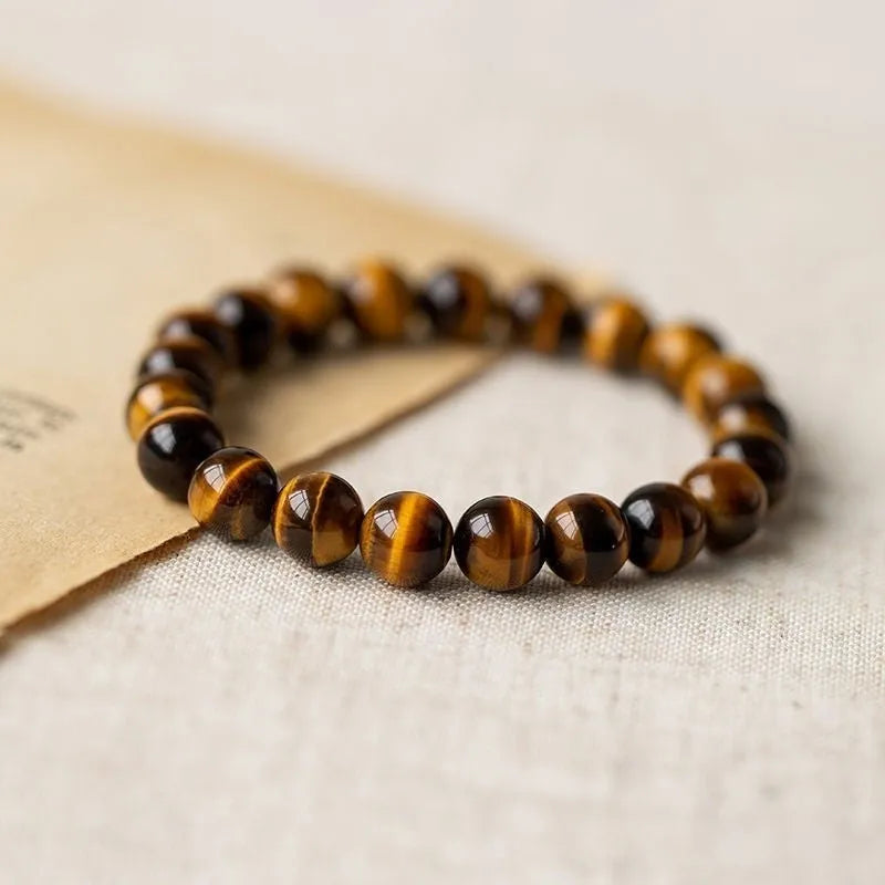Ethnic style tigereye Dzi bead simplicity Buddha rosary bracelet on display with multiple bead sizes