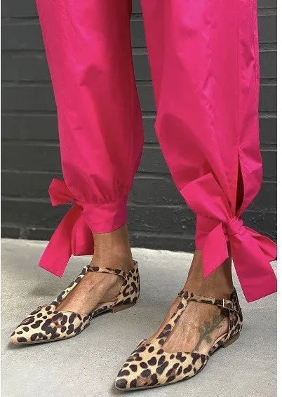 Leopard print women's pumps with pointed toe, chunky low heel, and ankle cross strap.
