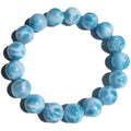 Blue Maillard-style Bodhi bracelet with a sea-pattern crystal stone and pearl accents on a wrist.