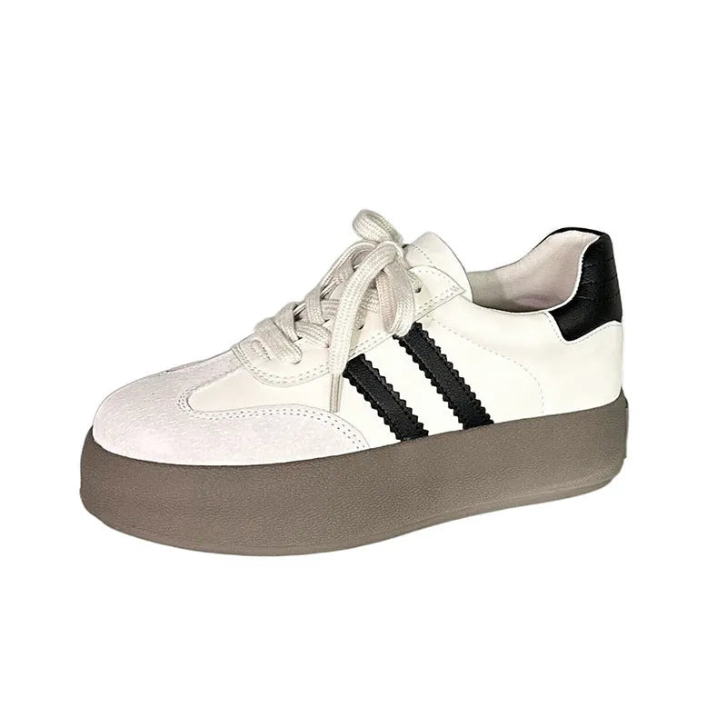 Women's beige vintage distressed lace-up sneakers with cowhide uppers and rubber sole.