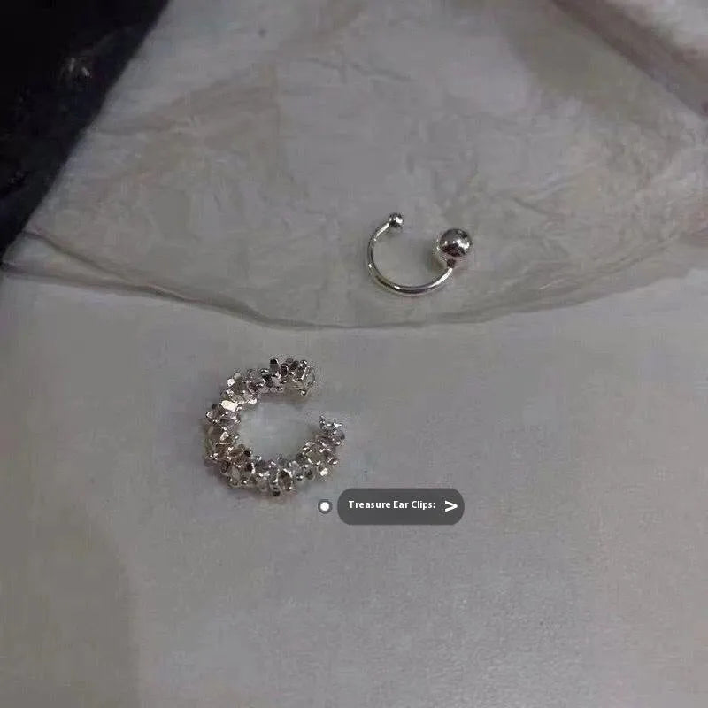 Pair of geometric irregular-shaped clip-on earrings with a frosty metallic finish.