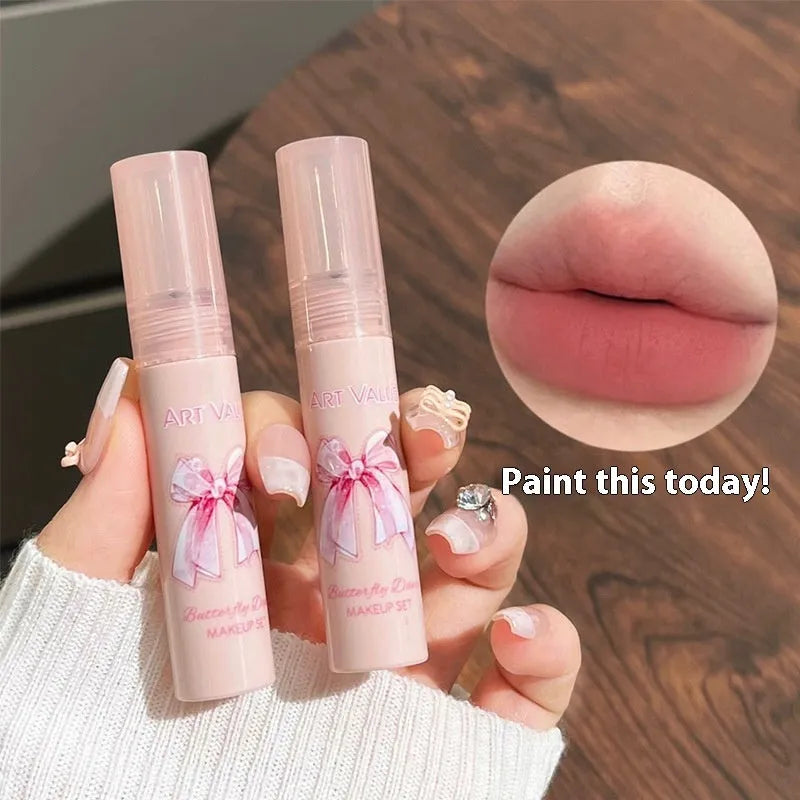 Butterfly Box makeup set showing four pink matte lip muds, powder blusher, and necklace