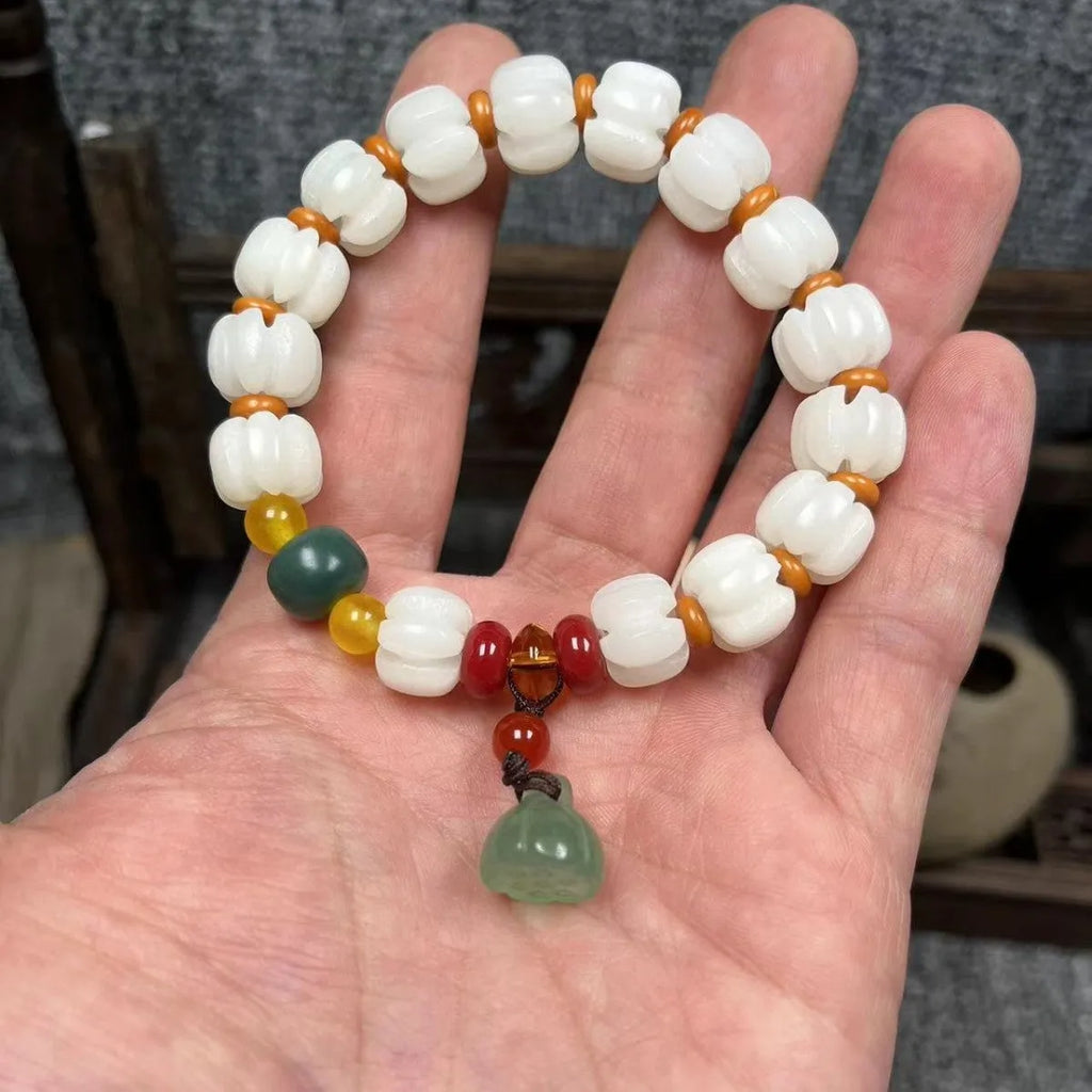 Hand-carved bodhi root bracelet with pumpkin lotus beads, white jade accents, and cat claw pendant