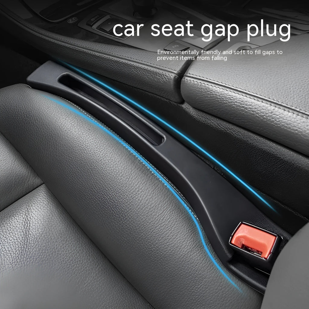 Black plastic car seat gap storage box with handle inserted between vehicle front seats.