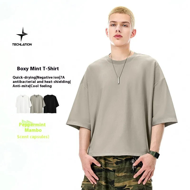 Men's sand grey short sleeve pullover showing loose fit and regular sleeve construction