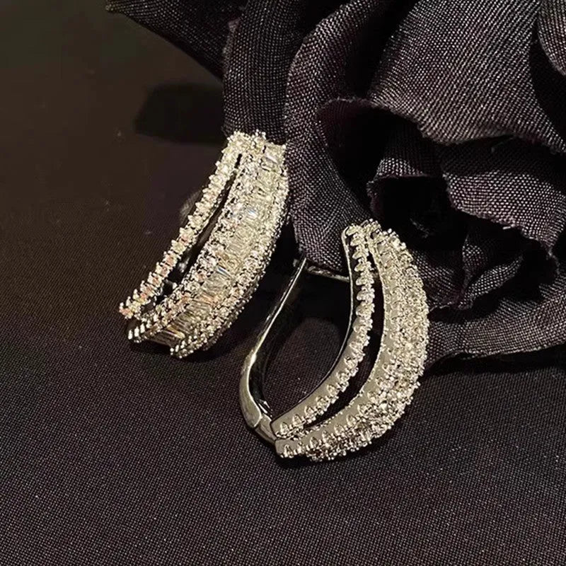 Geometric shaped white gold colour stud earrings with inlaid zircon stone for women.