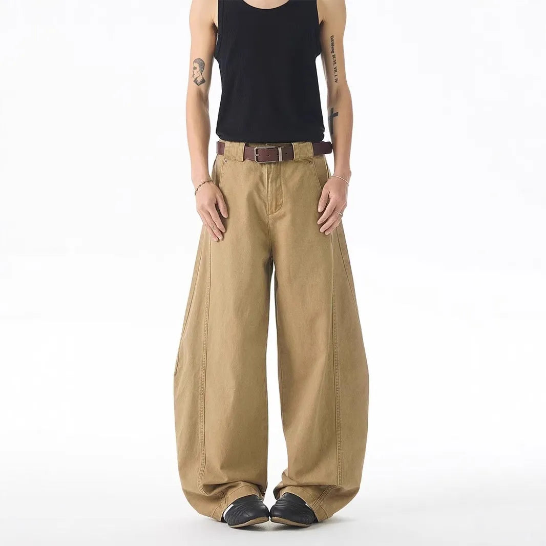 Brown men's loose-fit straight leg denim jeans with a button fly on a neutral background.