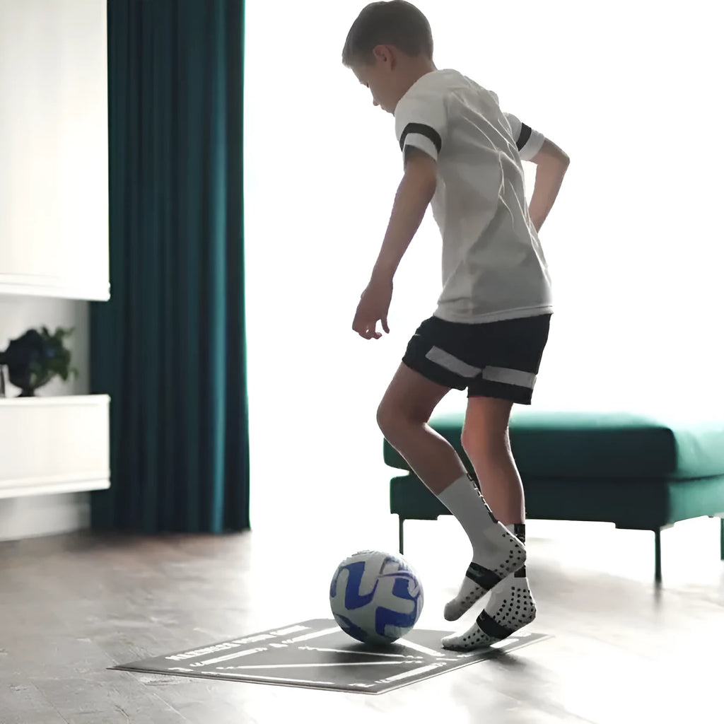 Black rectangular foam football training mat on a flat surface.