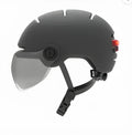 Cycling helmet with integrated LED light in two size options showing brake indicator function