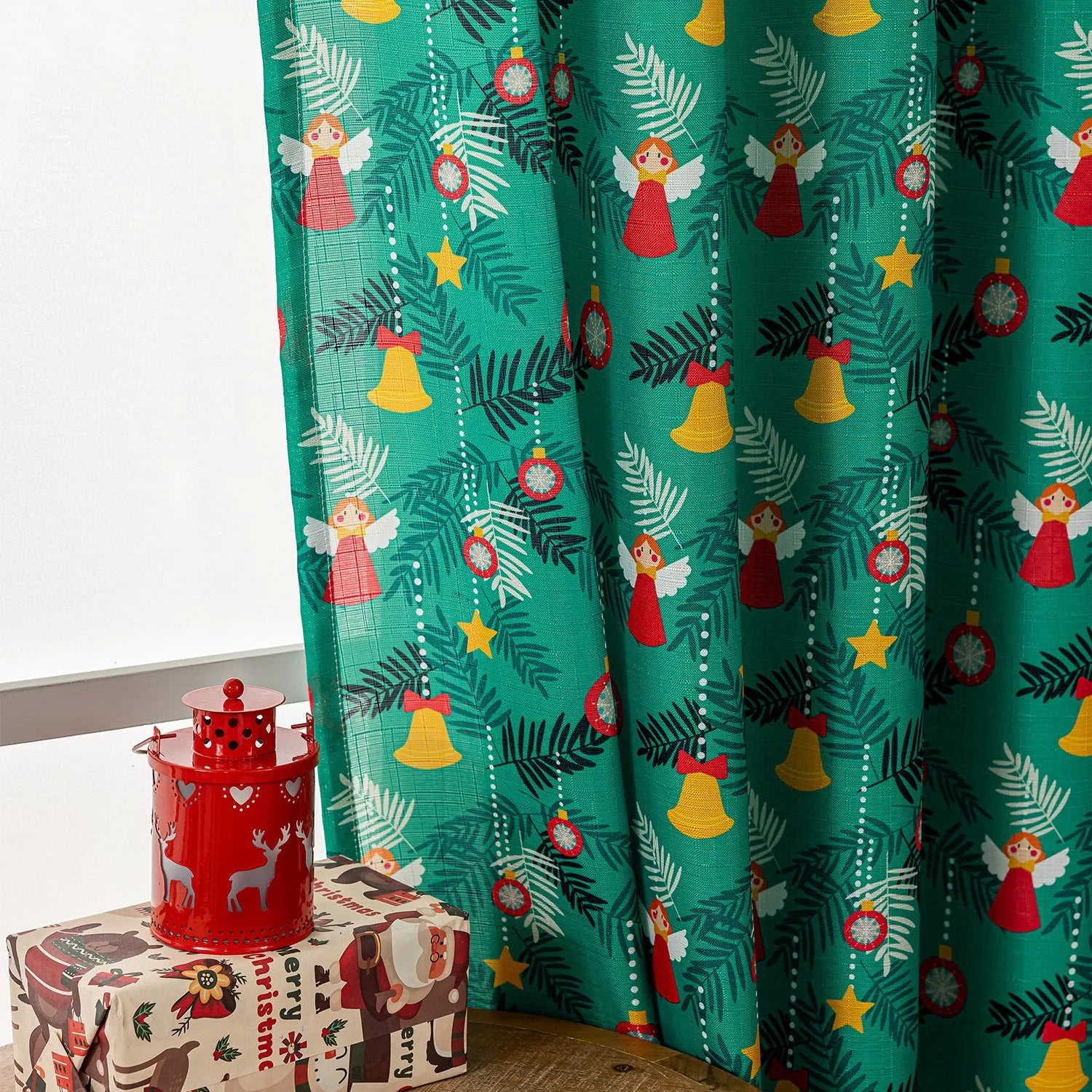 Green Christmas curtain with printed snowman and angel cartoon pattern, one metre wide.