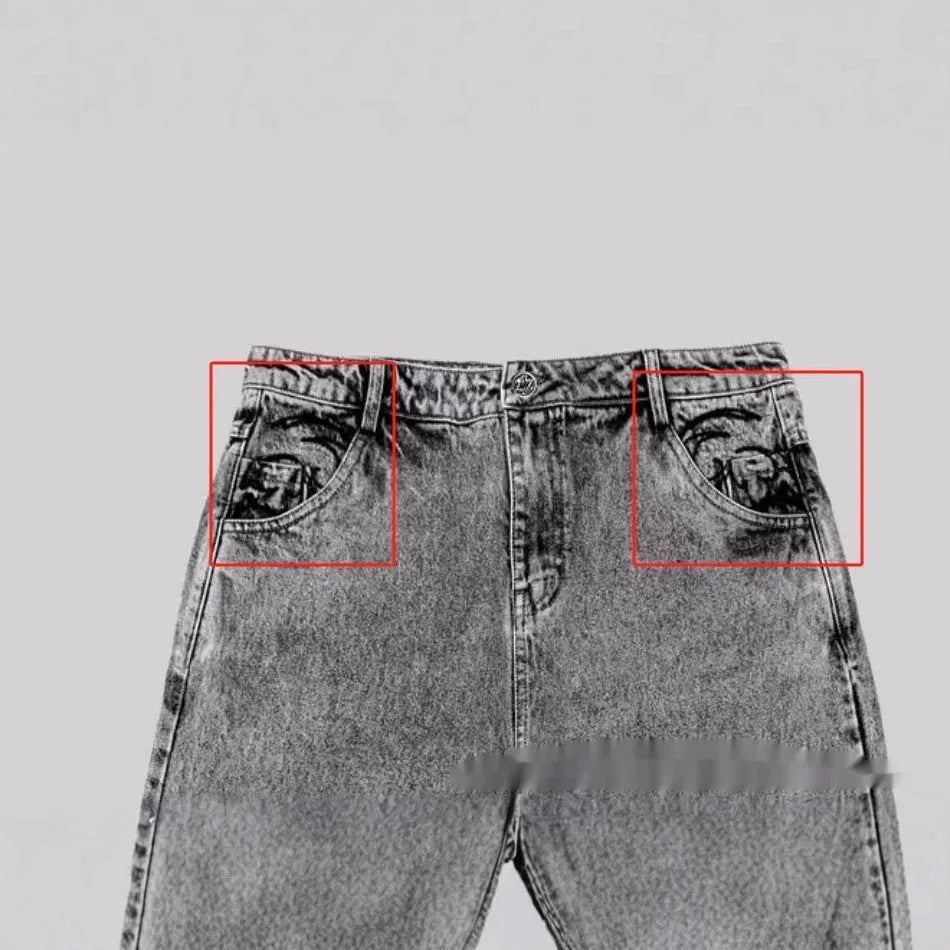 Grey loose fit straight leg denim trousers for men and women on a plain background