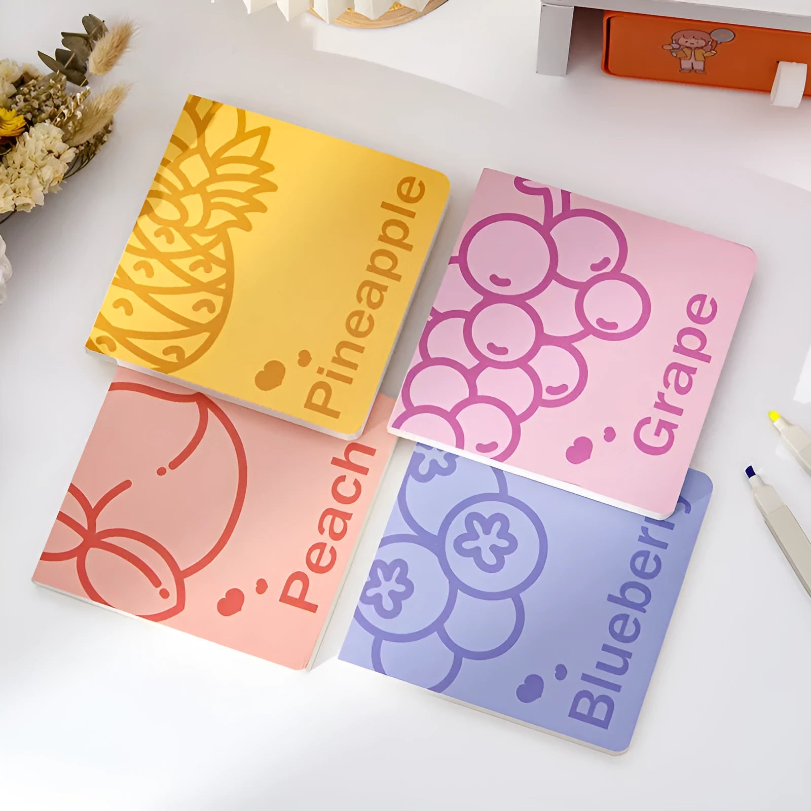 Square fruit pattern notebook with colour embossed cover showing pineapple design, 14.5cm dimensions